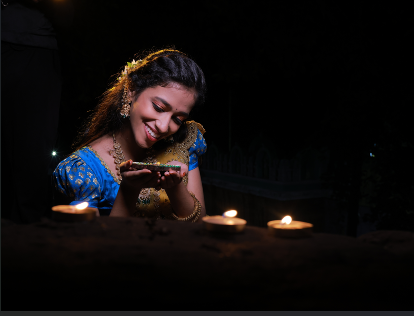 Honey at Diwali, holding a diya